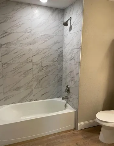 a bathroom with a bathtub and a toilet