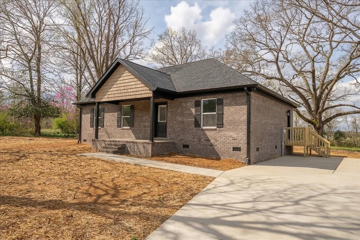 a front view of a house with yard and seating area