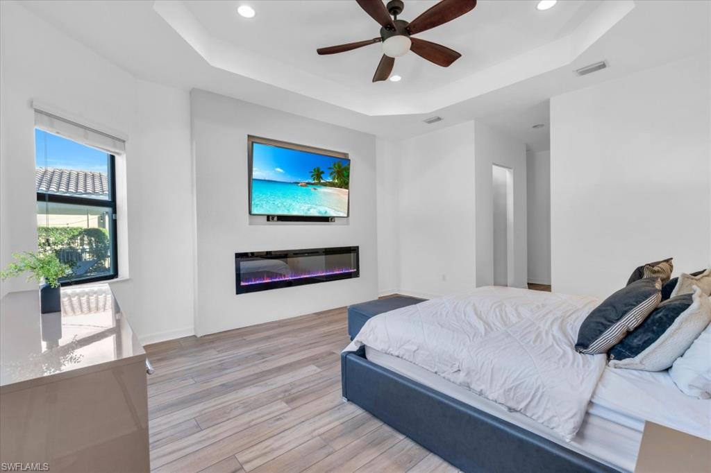 3376 Atlantic Circle Naples, FL 34119 - Photo 11 of 23 a bedroom with a bed and a painting on the wall