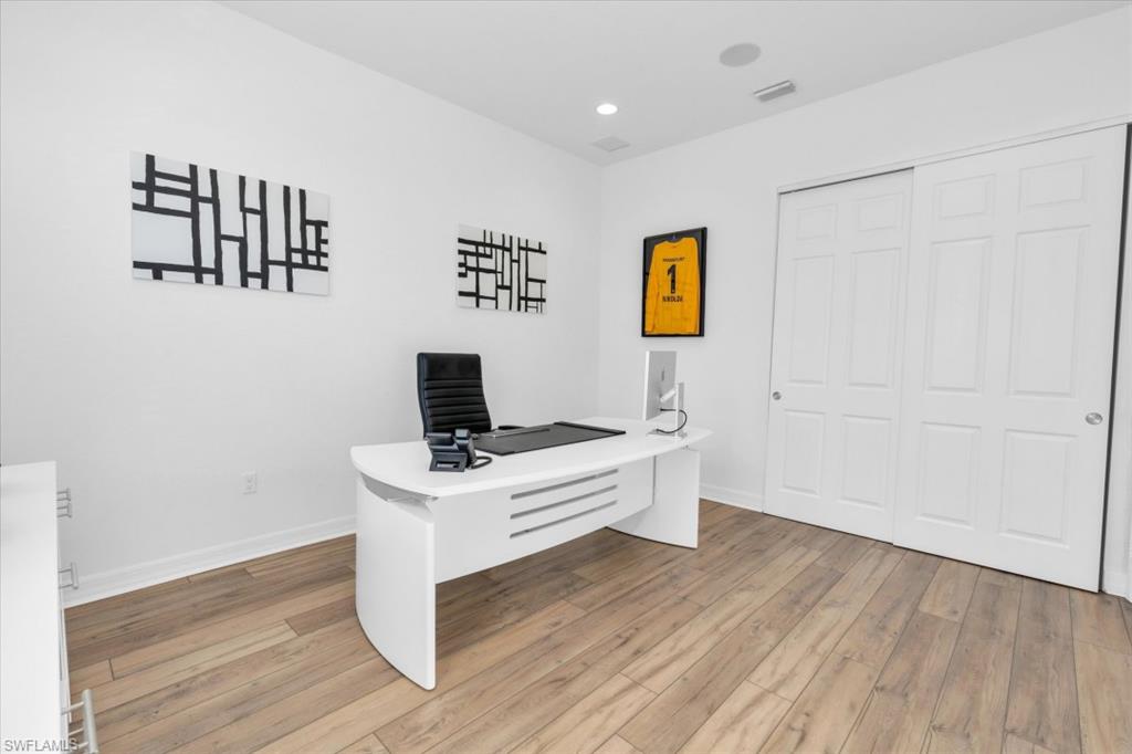 3376 Atlantic Circle Naples, FL 34119 - Photo 13 of 23 a workspace with furniture wall paintings and a window