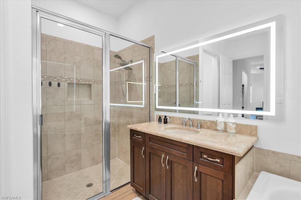 3376 Atlantic Circle Naples, FL 34119 - Photo 14 of 23 a bathroom with a sink and a mirror