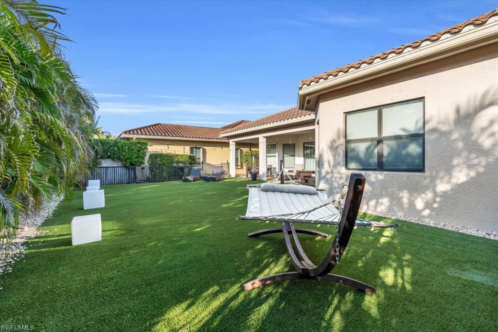 3376 Atlantic Circle Naples, FL 34119 - Photo 16 of 23 a view of a chair and table in backyard of the house