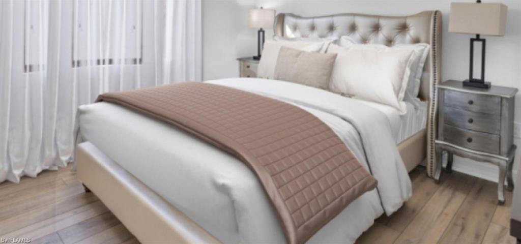 3376 Atlantic Circle Naples, FL 34119 - Photo 19 of 23 a bed sitting in a bedroom next to a lamp