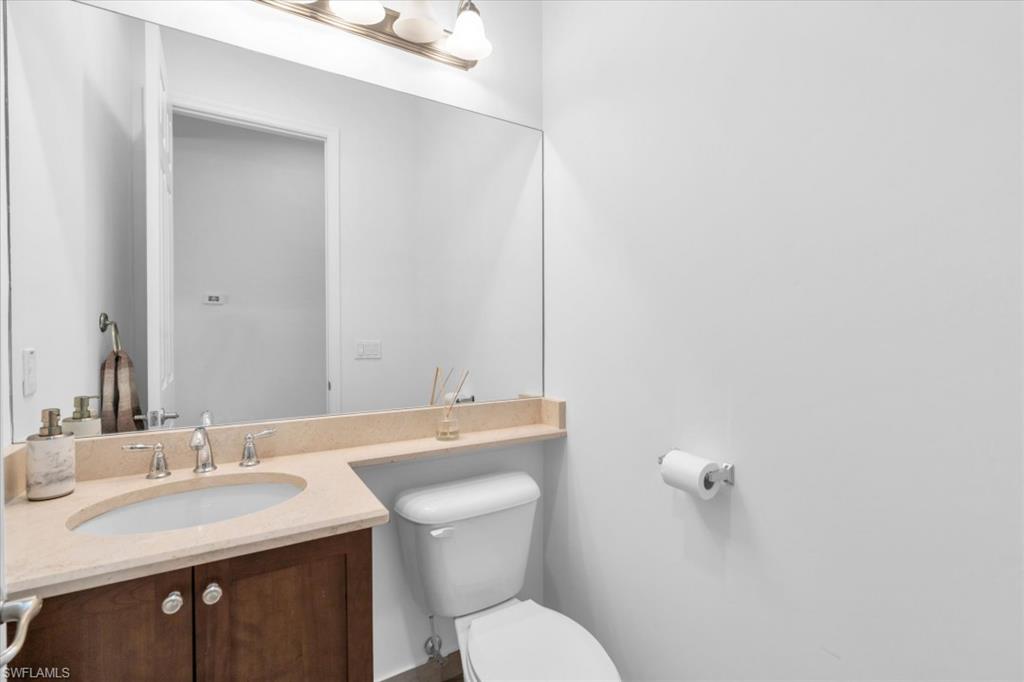 3376 Atlantic Circle Naples, FL 34119 - Photo 20 of 23 a bathroom with a toilet sink and mirror