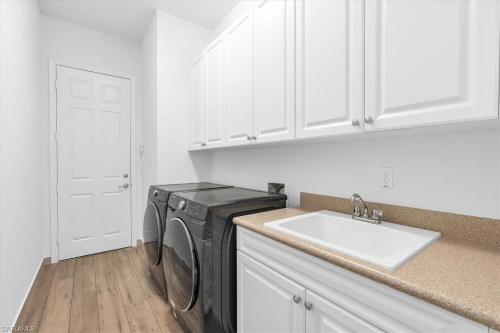 3376 Atlantic Circle Naples, FL 34119 - Photo 21 of 23 a utility room with dryer and washer