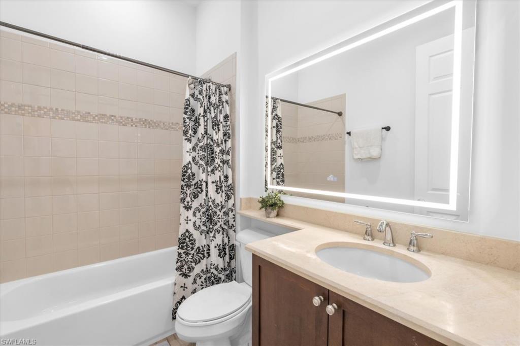 3376 Atlantic Circle Naples, FL 34119 - Photo 22 of 23 a bathroom with a sink a toilet and shower