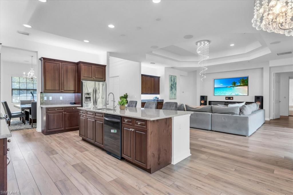 3376 Atlantic Circle Naples, FL 34119 - Photo 3 of 23 a large kitchen with stainless steel appliances and view living room