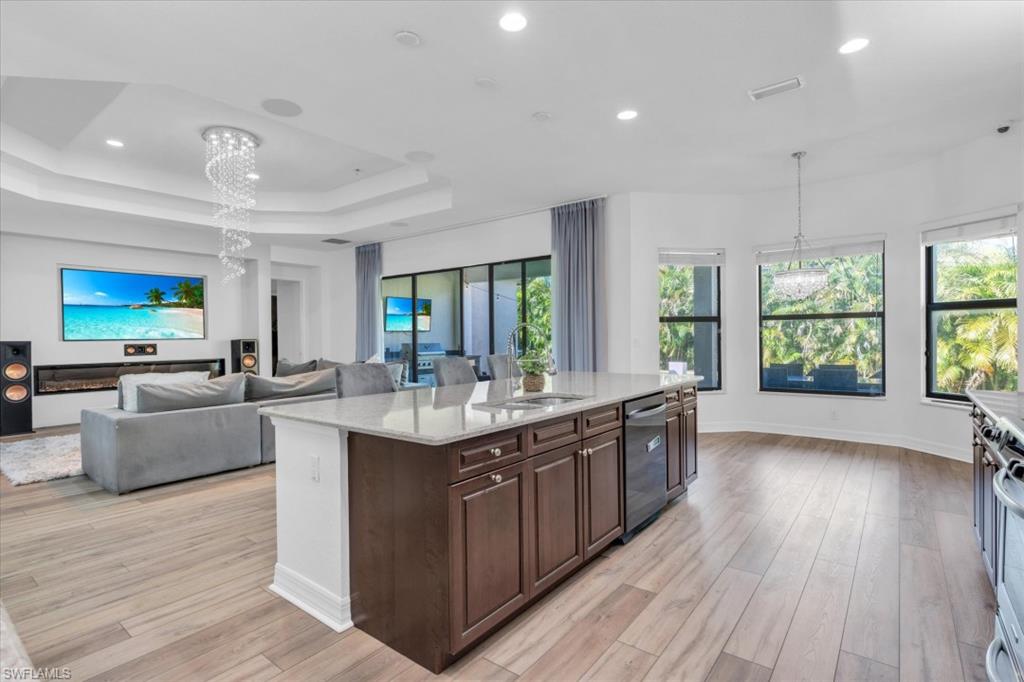 3376 Atlantic Circle Naples, FL 34119 - Photo 4 of 23 a large kitchen with stainless steel appliances granite countertop a lot of counter space and wooden floors
