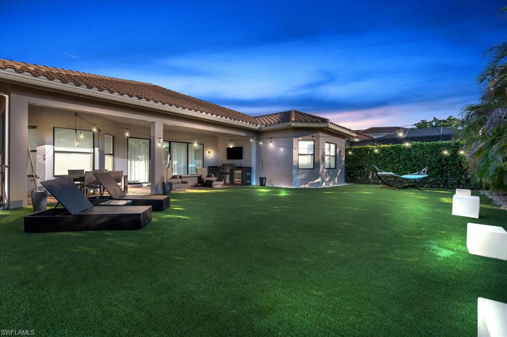 3376 Atlantic Circle Naples, FL 34119 - Photo 5 of 23 a view of a house with a big yard