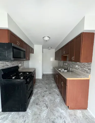 a kitchen with a stove and a refrigerator