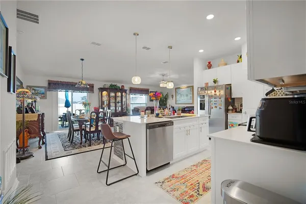 a kitchen that has a lot of cabinets a sink and a stove in it