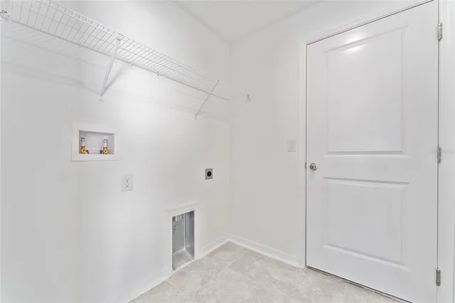 a view of storage and utility room with closet