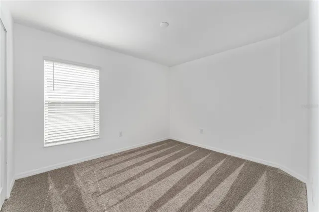 a view of an empty room and closet