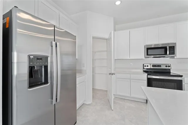 a kitchen with cabinets and stainless steel appliances