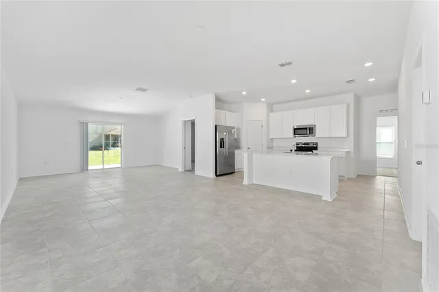 a view of a kitchen with a refrigerator a sink and a stove