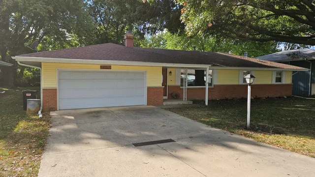 a view of a house with a yard and garage