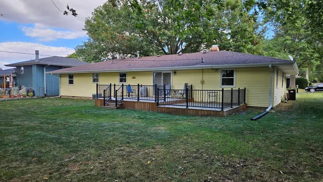 a view of a house with a yard and a table
