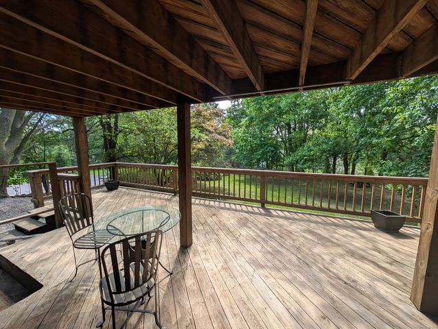 a view of a wooden deck with a backyard