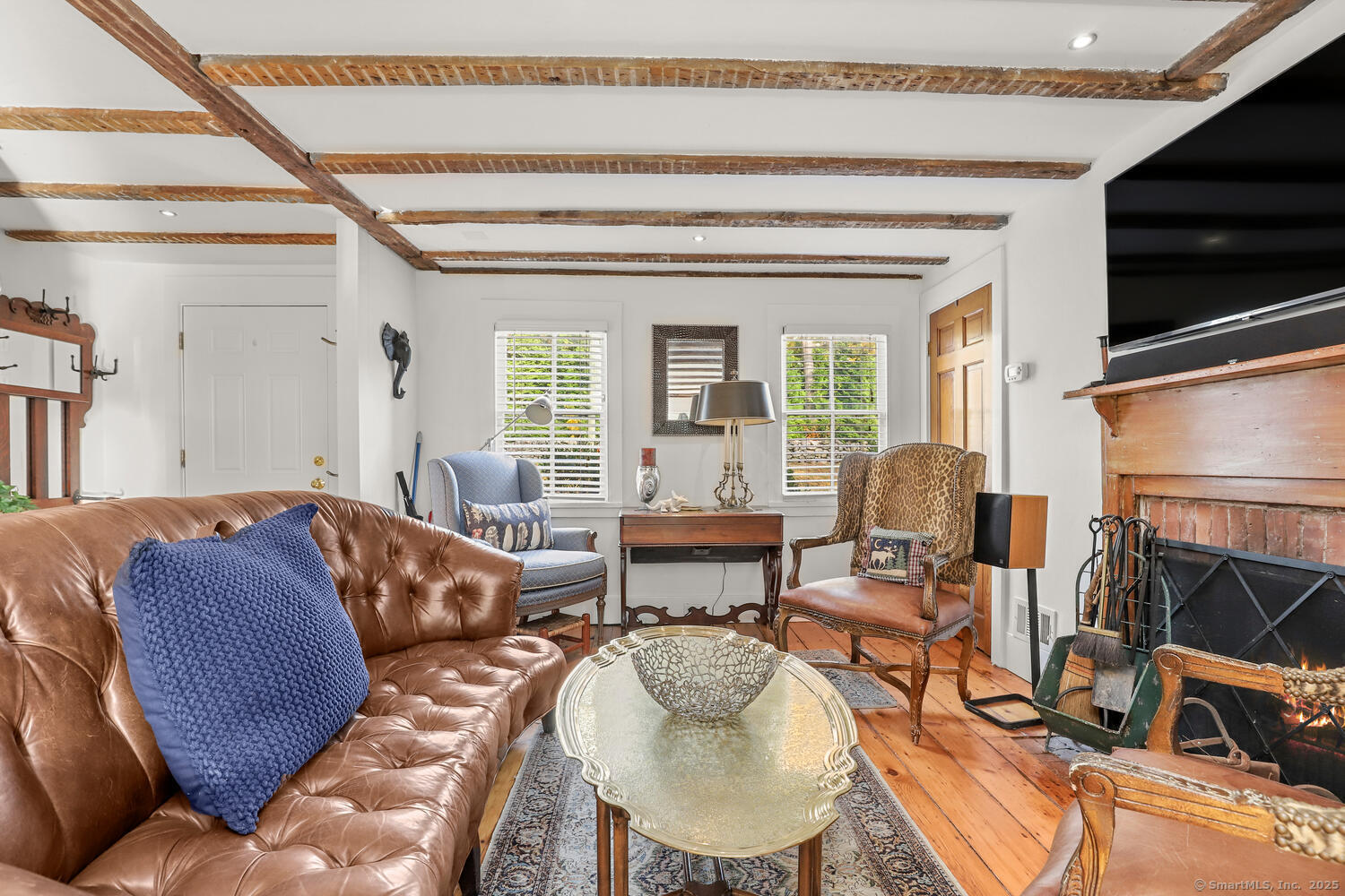 47 Hollow Tree Ridge Road Darien, CT 06820 - Photo 23 of 40 a living room with furniture a flat screen tv and a window