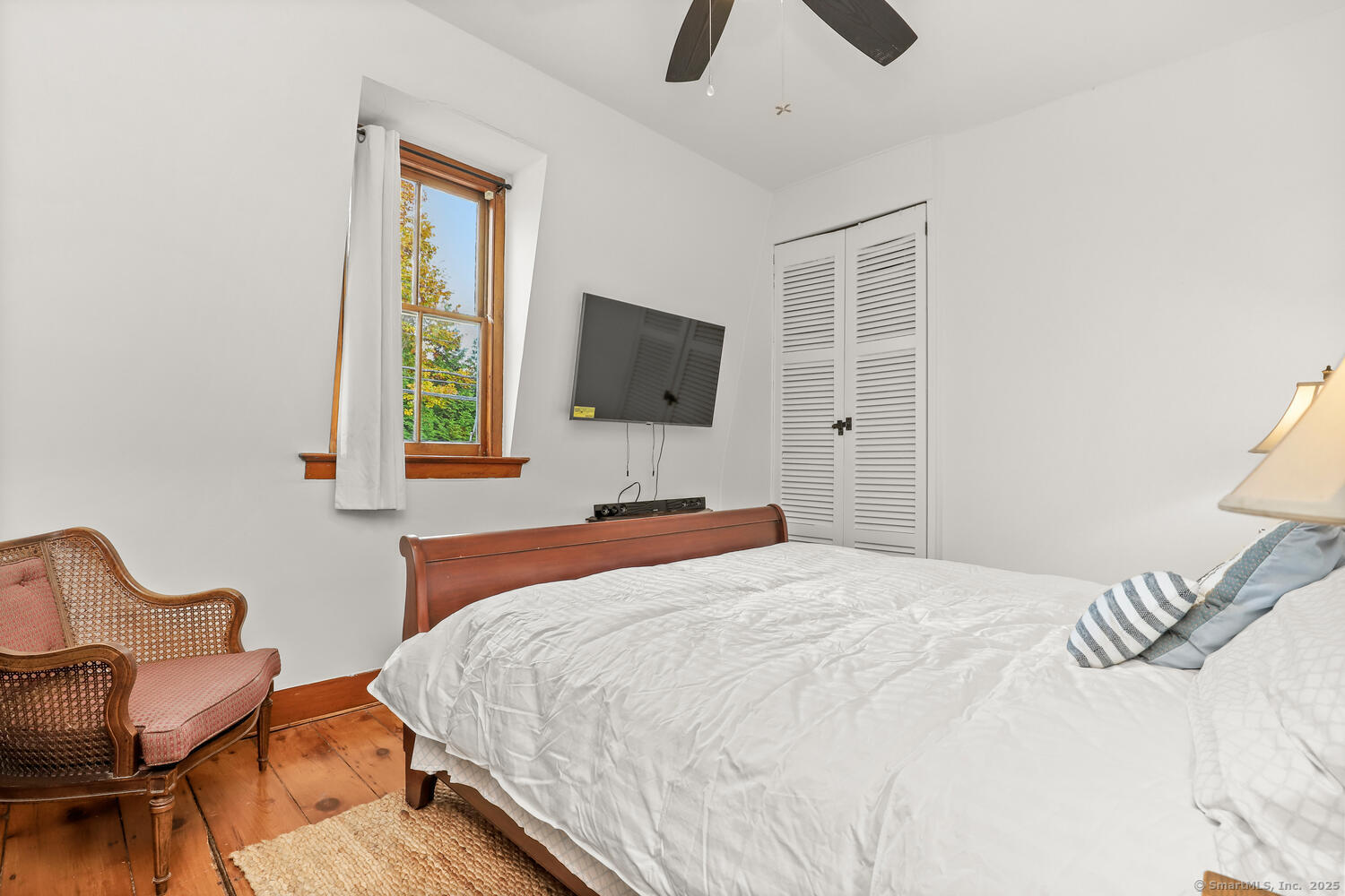 47 Hollow Tree Ridge Road Darien, CT 06820 - Photo 27 of 40 a bedroom with a bed and chair