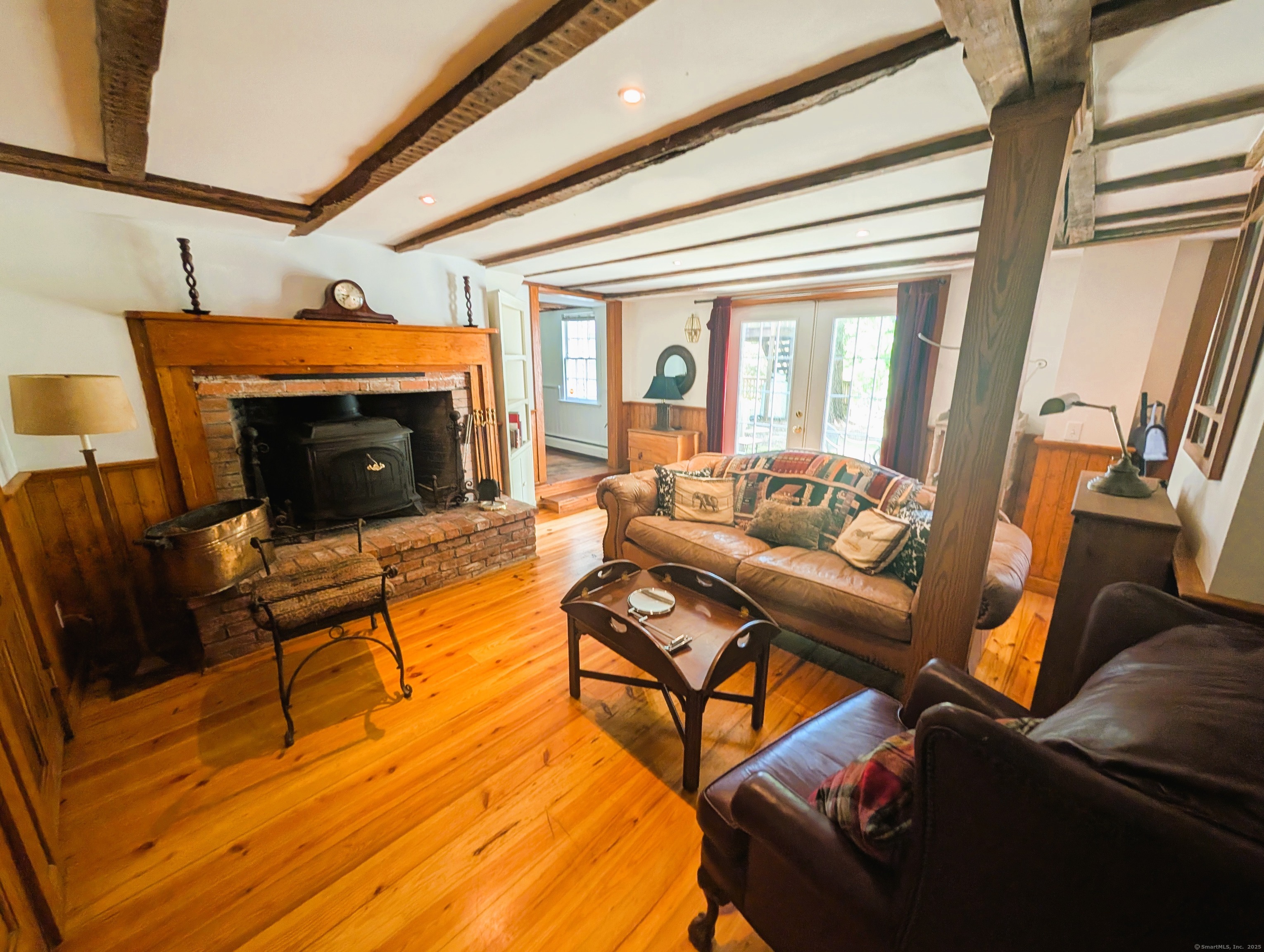 47 Hollow Tree Ridge Road Darien, CT 06820 - Photo 28 of 40 a living room with furniture a fireplace and wooden floor