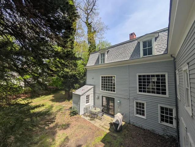 a house that has a tree in front of the house