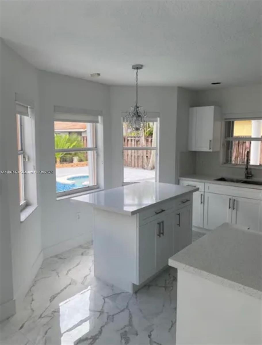 16461 Southwest 100th Terrace Miami, FL 33196 - Photo 5 of 18 a kitchen with sink cabinets and window