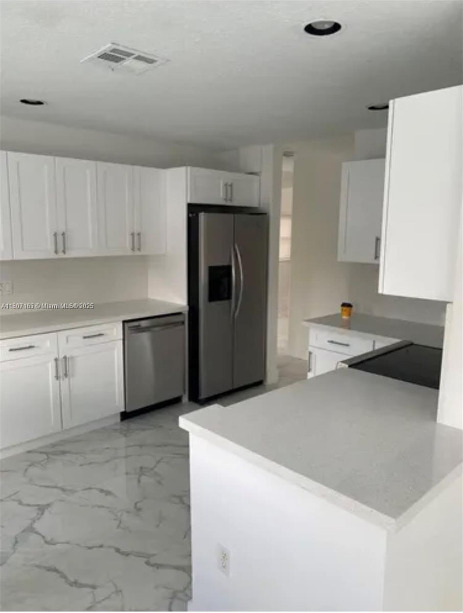 16461 Southwest 100th Terrace Miami, FL 33196 - Photo 7 of 18 a kitchen with granite countertop a sink stove and refrigerator