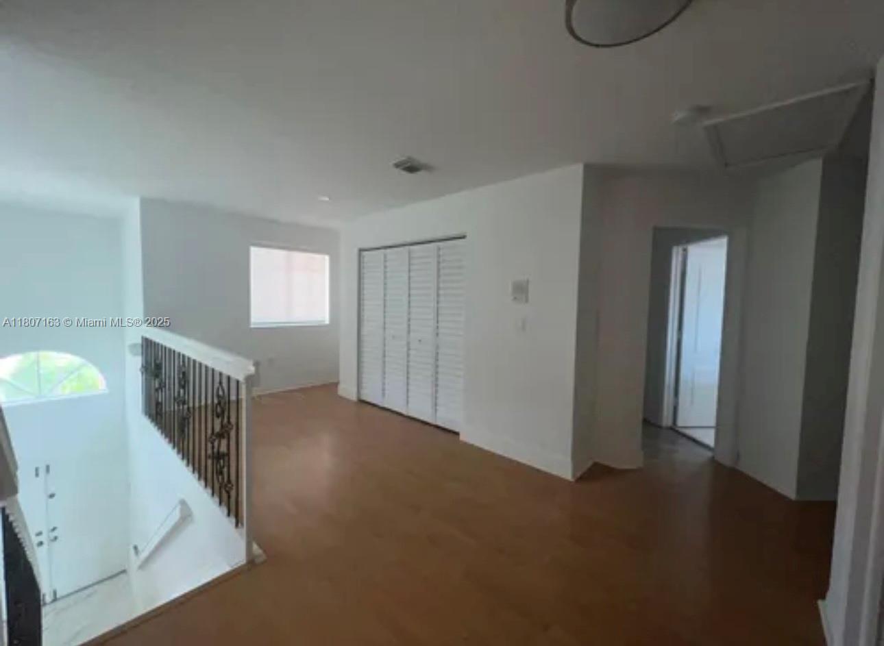 16461 Southwest 100th Terrace Miami, FL 33196 - Photo 9 of 18 a view of empty room with windows and fan