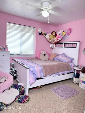 a bedroom with a bed dresser and a window