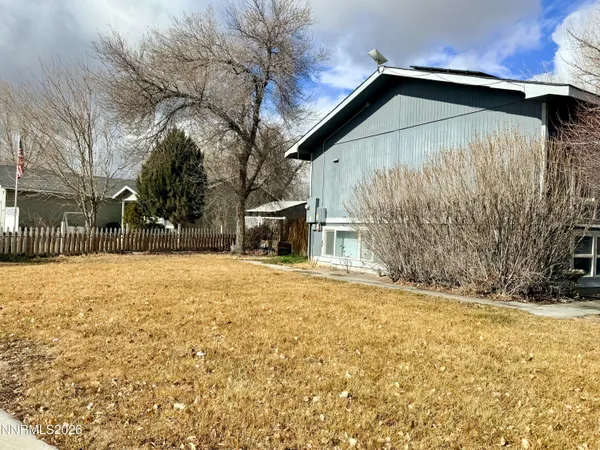 a yellow house with trees in front of it