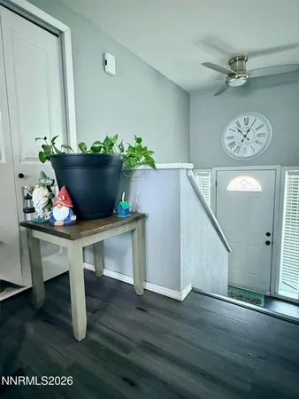a view of a room with furniture and wooden floor