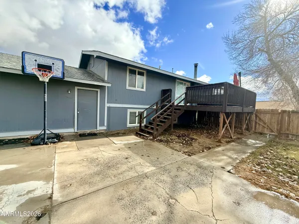 a backyard of a house with table and chairs
