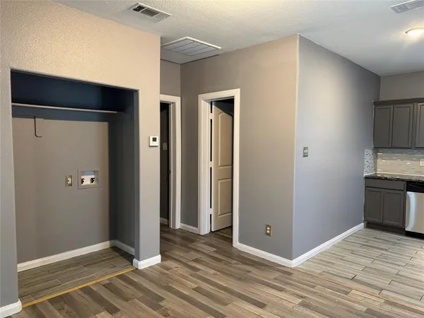 a view of a livingroom with wooden floor and a ceiling fan