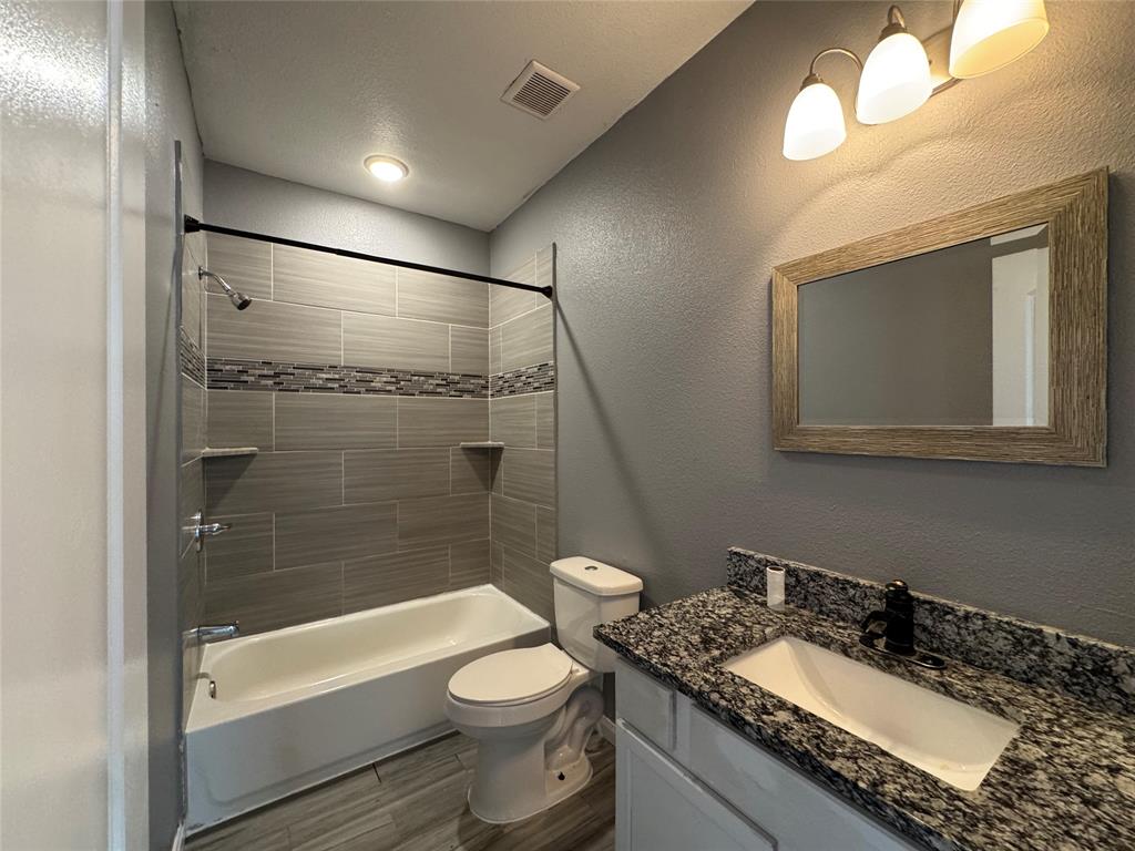 7315 Toland Street Dallas, TX 75227 - Photo 9 of 16 a bathroom with a granite countertop sink toilet and shower