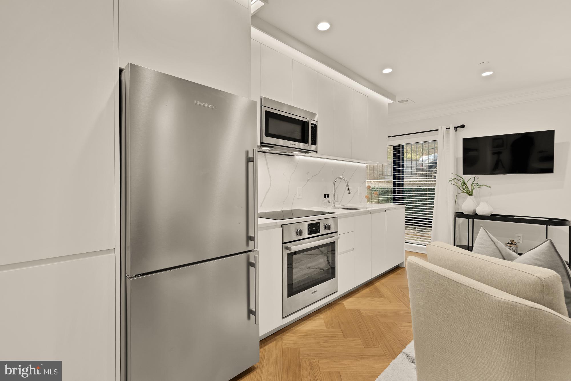 2630 39th Street Northwest, Unit 1 Washington, DC 20007 - Photo 11 of 26 a kitchen with stainless steel appliances a refrigerator stove microwave and sink