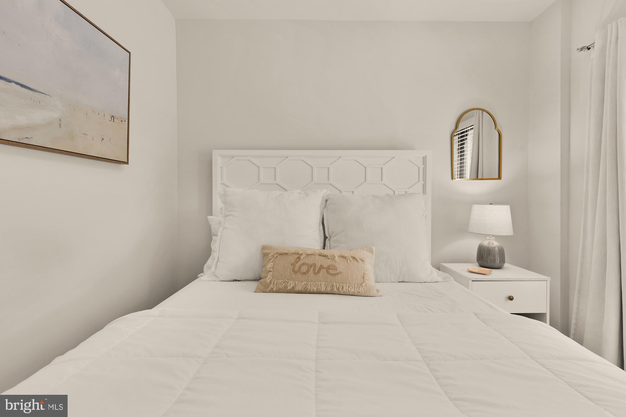 2630 39th Street Northwest, Unit 1 Washington, DC 20007 - Photo 17 of 26 a bedroom with a bed and a lamp on dresser