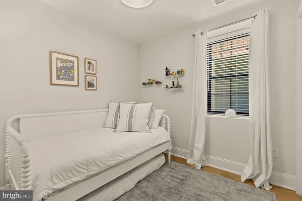 a bed room with a bed and a window