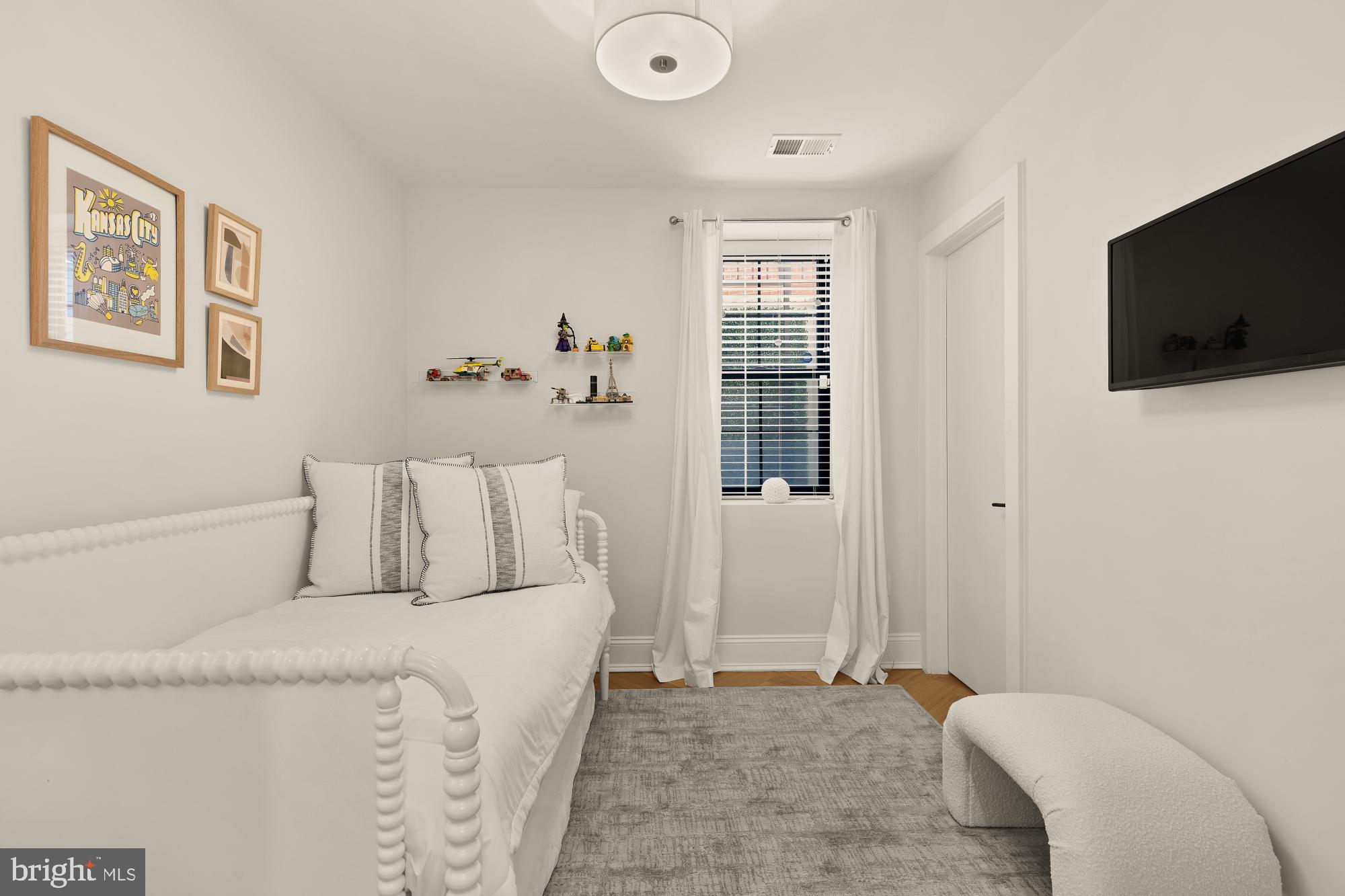 2630 39th Street Northwest, Unit 1 Washington, DC 20007 - Photo 22 of 26 a bed room with a bed a television and a window