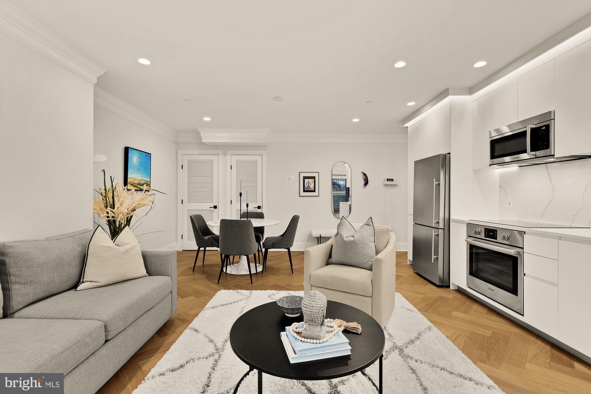2630 39th Street Northwest, Unit 1 Washington, DC 20007 - Photo 5 of 26 a living room with furniture a flat screen tv and kitchen view