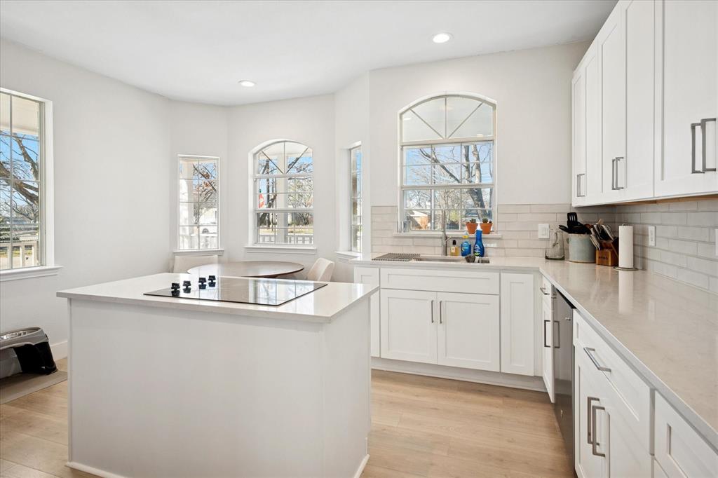 437 South 1st Street Krum, TX 76249 - Photo 17 of 38 a kitchen with sink a microwave and cabinets