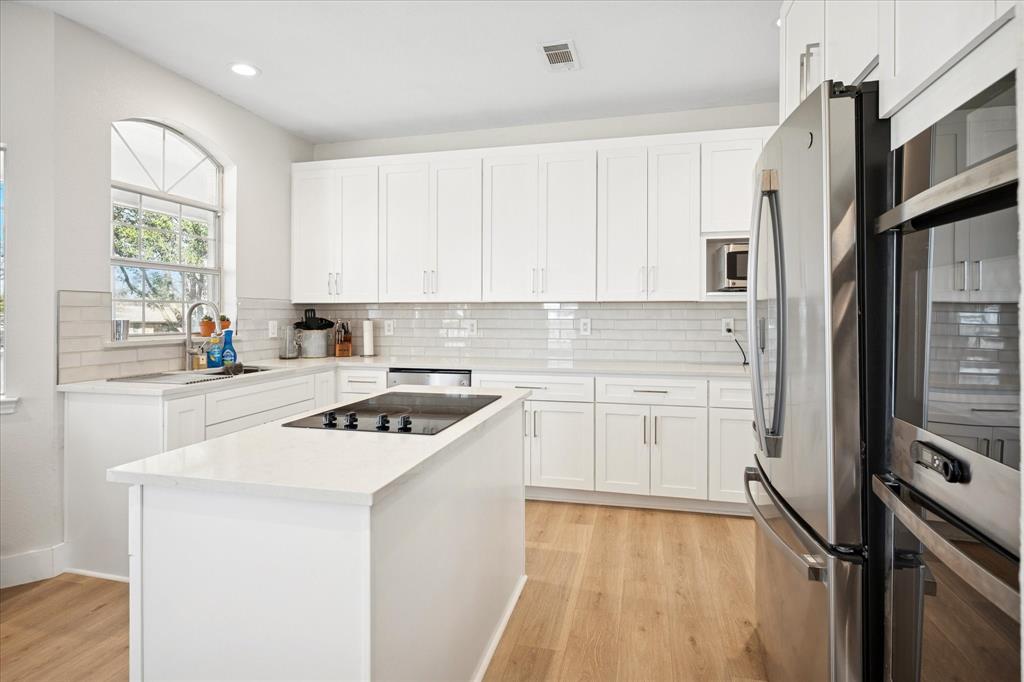 437 South 1st Street Krum, TX 76249 - Photo 18 of 38 a kitchen with a refrigerator sink and stove
