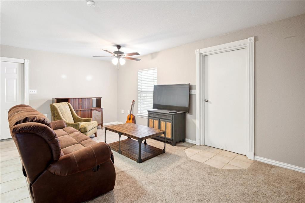 437 South 1st Street Krum, TX 76249 - Photo 30 of 38 a living room with furniture and a flat screen tv