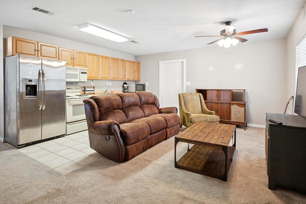 437 South 1st Street Krum, TX 76249 - Photo 31 of 38 a living room with furniture and a large window