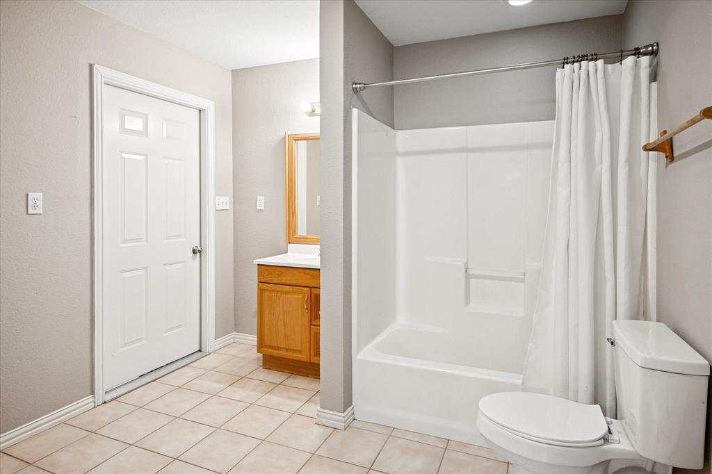 437 South 1st Street Krum, TX 76249 - Photo 34 of 38 a bathroom with a tub and a shower