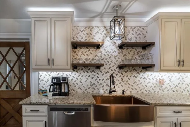 a view of a backyard with potted plants and a table and chair