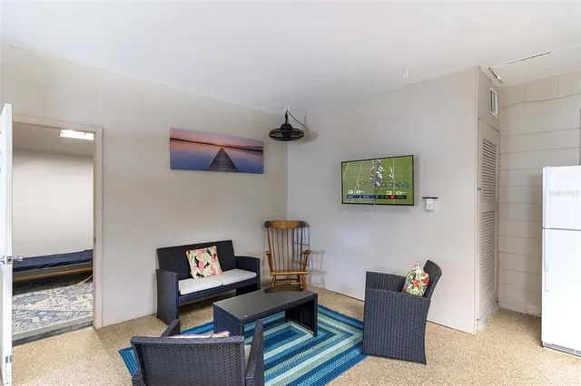 a view of a chair and table in backyard of the house