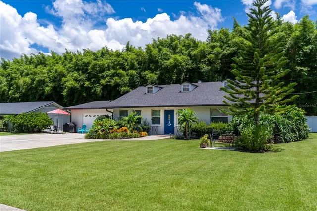 a kitchen with stainless steel appliances granite countertop a sink and dishwasher a stove top oven with wooden floor