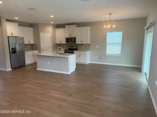 a kitchen with stainless steel appliances a refrigerator sink and microwave