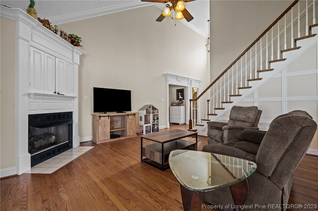 6407 Cattesmore Road Fayetteville, NC 28311 - Photo 11 of 42 a living room with furniture a flat screen tv and a fireplace